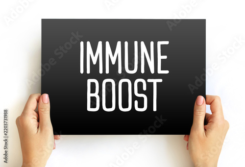IMMUNE BOOST text held by hands. Health improvement concept focused on enhancing natural immunity and physical well-being through professional medical advice and proper care.