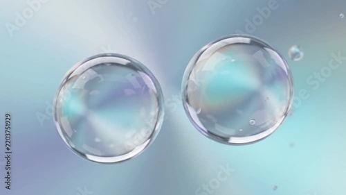 transparent water drops merging and floating on iridescent gradient background