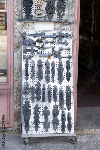 Assortment of traditional iron hardware for doors on display.