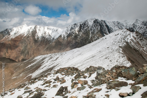 Landscape view of snow-covered Altai wilderness in August seen from the peak of the Pyramid mountain, Russian Federation