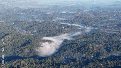 Lush tropical ridges and riverine mist weaving through forested valleys near Tumpak Sewu.