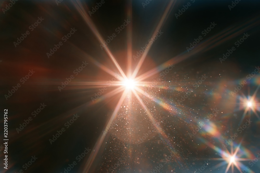 Obraz premium Bright starburst lens flare with sparkling particles in