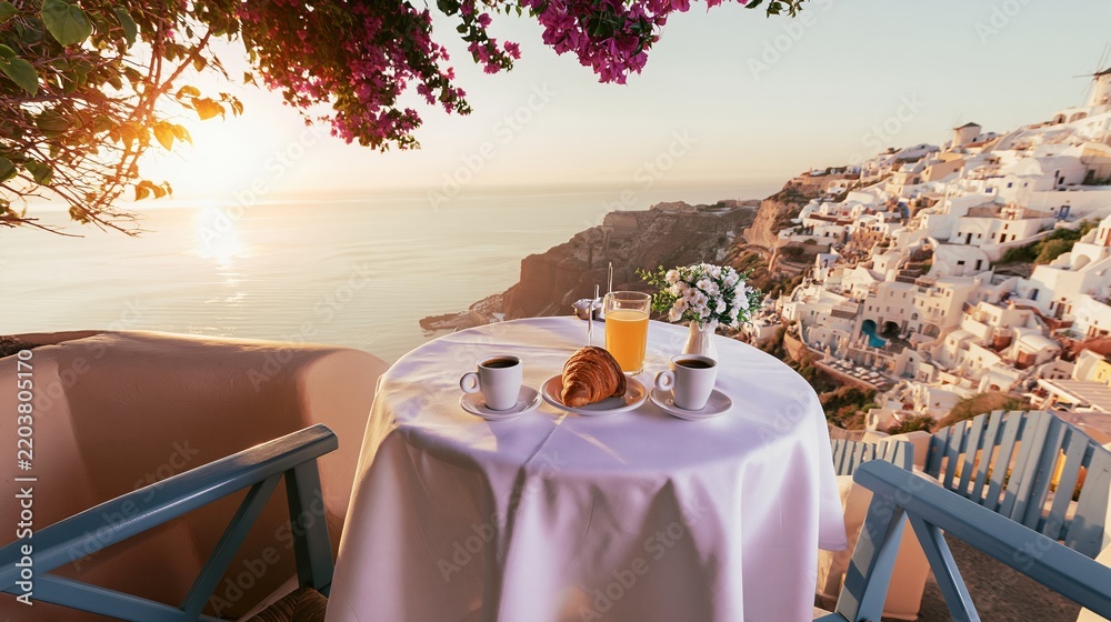 Fototapeta premium romantic breakfast table overlooking caldera sunset
