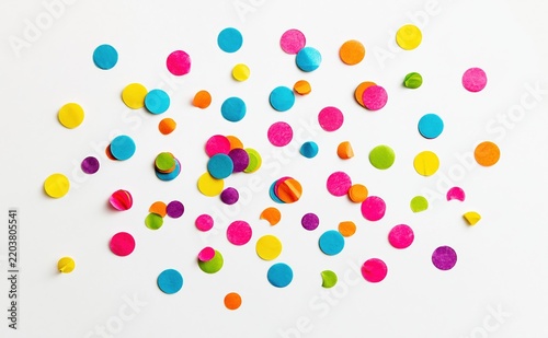 Colorful paper confetti scattered on white background