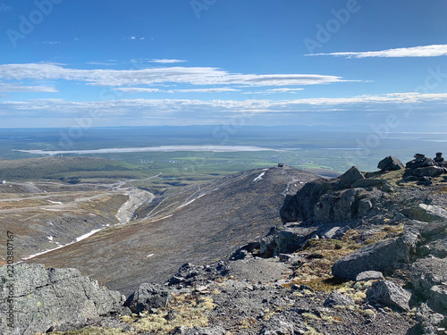 Rugged Khibiny mountains with cliffs and distant lake near Kirovsk, Russia, June 2019