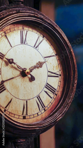 A close-up shot of a clock with Roman numerals, ideal for designs related to timekeeping or historical themes vertical frame