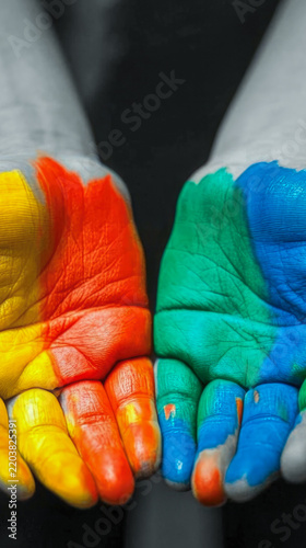 A creative and colorful representation of two hands with unique paint jobs vertical frame