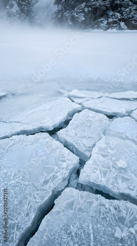 Frozen lake with cracked ice surface.
