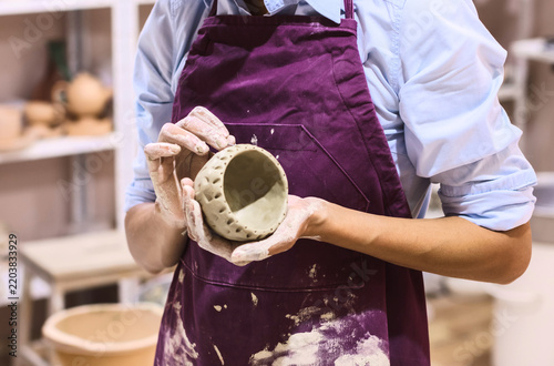 Handmade clay bowl held during pottery work