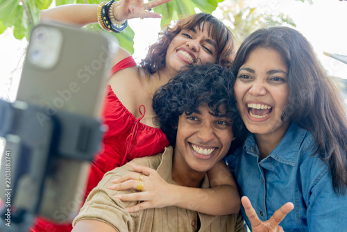 Young Indian Gen Z friends taking fun selfies together outdoors, smiling and posing for the camera, representing friendship, social media, youth culture, digital lifestyle and modern urban life.