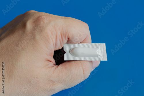 Fotografie Hand Holding Suppository Blister Pack Medicine for Rectal Treatment and Symptom