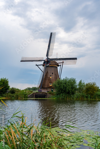 Old windmill in front of a river in Kinderdijk