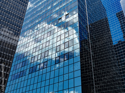 Close-up view of a business office tower's mirrored glass facade in Manhattan.