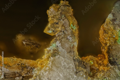 Macro photography of real raw quartz crystal showing prismatic mineral formations and natural geological structures on golden brown bokeh background for science education