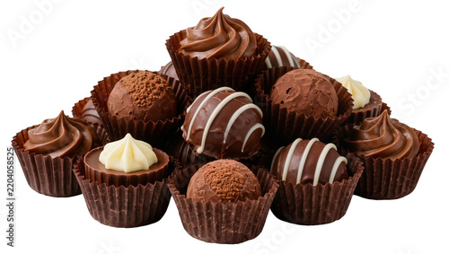 Assorted chocolate truffles with white cream topping, isolated on transparent background