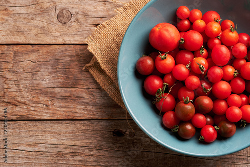 Fresh Cherry Tomatoes in a Blue Bowl on a Wooden Table