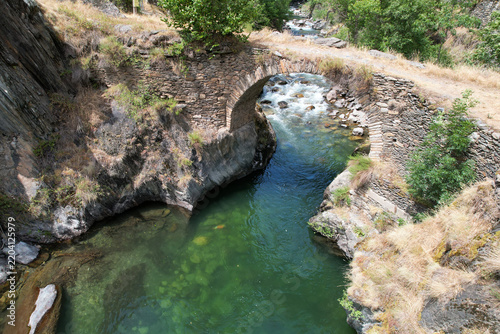 Aerial view of Romanesque Bridge of Arreu on sunny summer day. Boren, Lleida, Spain.