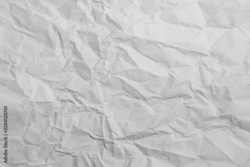 Fototapeta premium Heavily crumpled white paper texture background with detailed wrinkles and folds