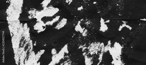 Black paper texture with peeled surface damage, scattered white exposed paper patches, torn upper coating, rough abrasion marks, and distressed scanned wear detail on black background
