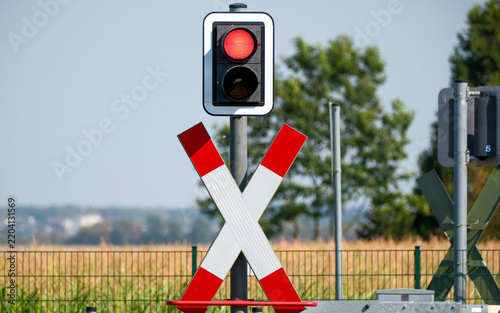 Red light glows on the railroad crossing signal