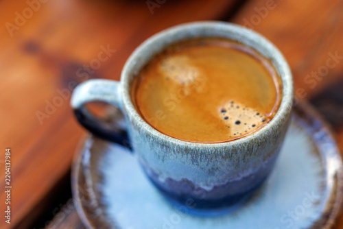 Close up view of fresh hot espresso coffee in ceramic mug