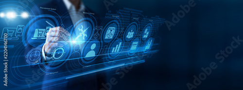 Fotografie Business consultant pointing the pen configuring Enterprise Resource Planning systems on a vast virtual screen