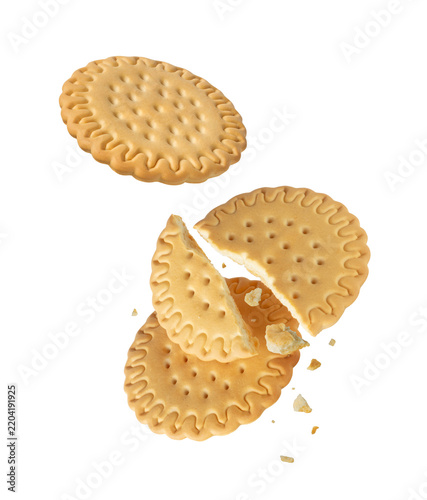 Whole and crushed sweet biscuits stacked close-up on transparent background