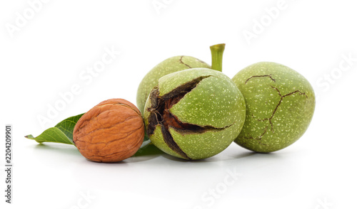 Foto Walnuts with green husk and leaf isolated on white background.
