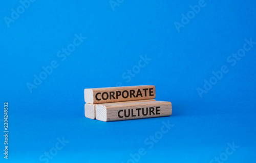 Corporate culture symbol. Concept word Corporate culture on wooden blocks. Businessman hand. Beautiful blue background. Business and Corporate culture concept. Copy space