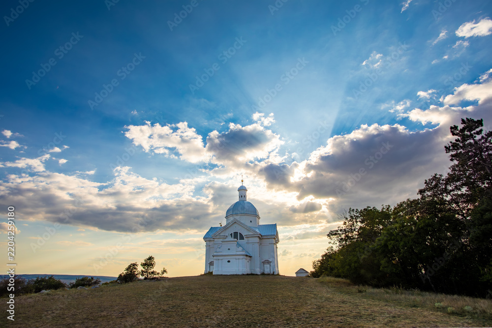 Obraz premium San Sebastian Chapel Hilltop Scenic Landmark Under Dramatic Sky Rays Czech Republic