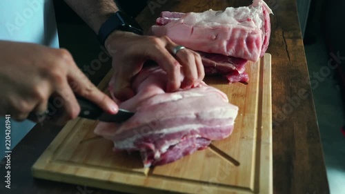 Cutting Pork Belly into Portions on Cutting Board