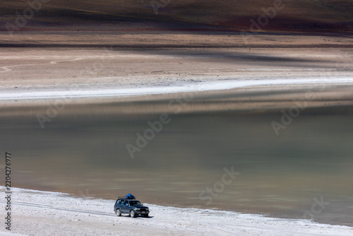 SUV Driving on Salt Flat Lake Landscape