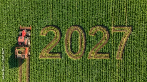 Tractor creating year 2027 numbers in green agricultural