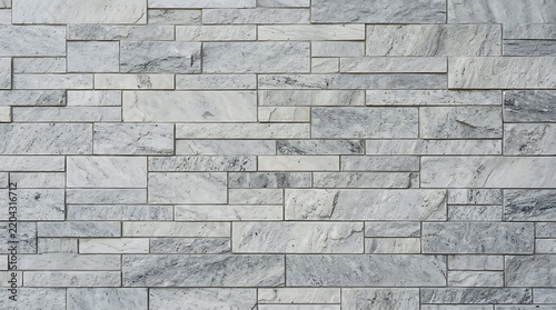 Modern light gray stone veneer wall cladding with textured rectangular blocks for architectural design