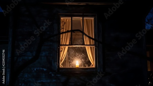 Candlelight glows in window.
