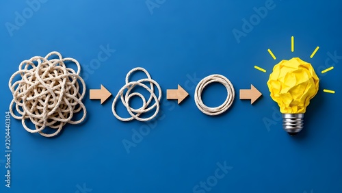 Concept of simplification and creative problem solving showing a tangled rope evolving through stages into a bright yellow lightbulb idea on a solid blue background.
