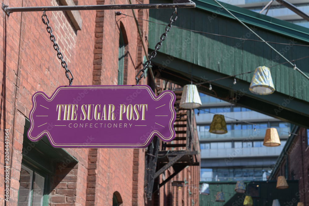 Fototapeta premium projecting novelty shaped signage outside The Sugar Post, a new candy store at the Distillery District, Toronto
