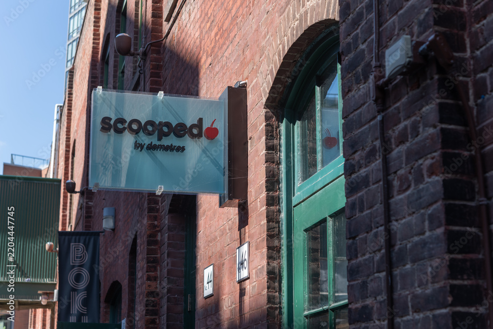Fototapeta premium wall-mounted projecting sign outside Scooped by Demetres (Distillery District) 46 Gristmill Lane, Toronto