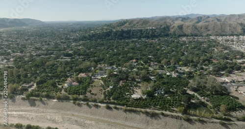 aerial view of suburban valley with town and houses