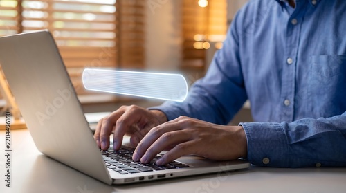 Professional man typing on laptop with glowing futuristic digital interface elements