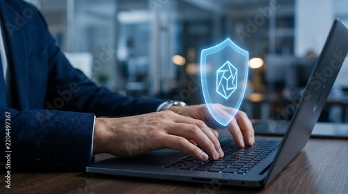 Businessman typing on laptop with bright blue digital security shield