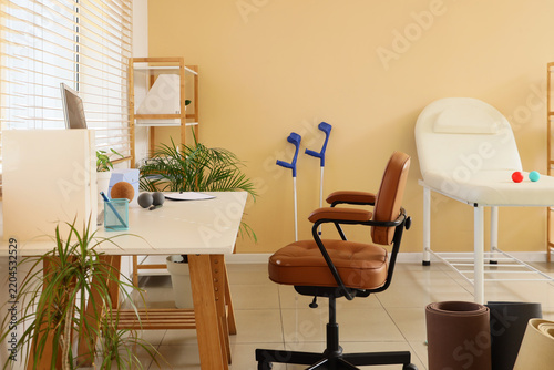 Physical therapy and rehabilitation clinic, medical office interior with crut...