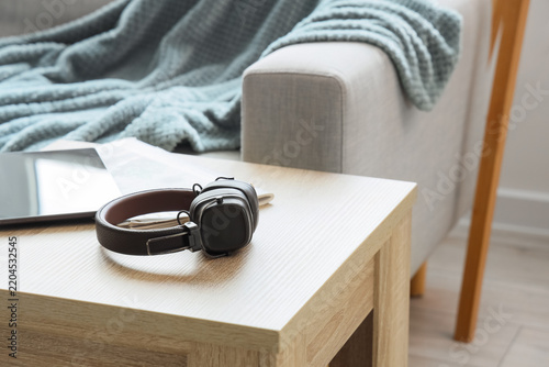 Work-life balance and remote work, headphones and tablet on a coffee table in...