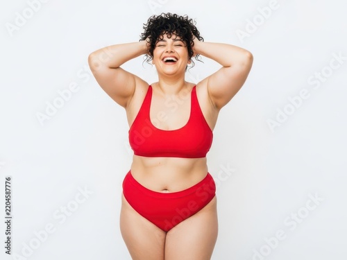 Happy woman laughing with hands on head
