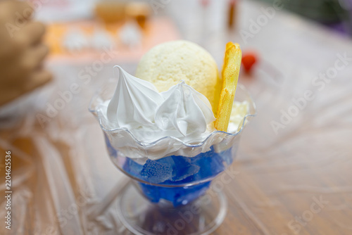 Hand piping fake whipped cream onto a replica dessert parfait at a DIY workshop