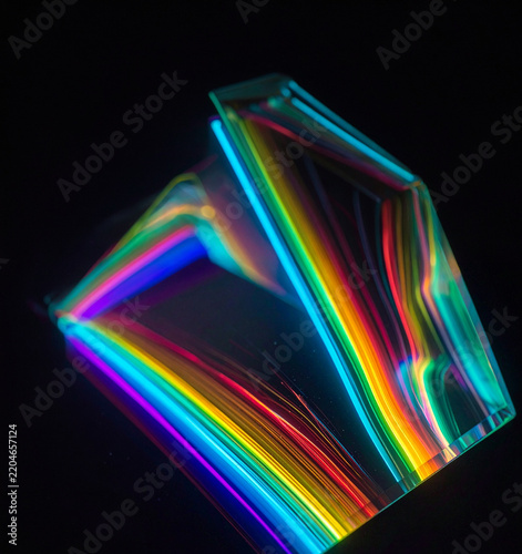 Geometric glass prism dispersion creating vibrant rainbow neon light rays on a dark background. Ideal for creative technology, physics optics concept, branding, and modern digital art campaigns.