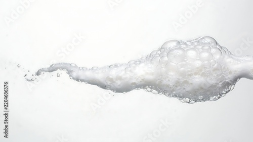 White soap bubbles and foam floating in the air isolated on a plain white background, with soft studio lighting