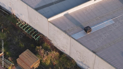 Aerial view of industrial building roof and backyard