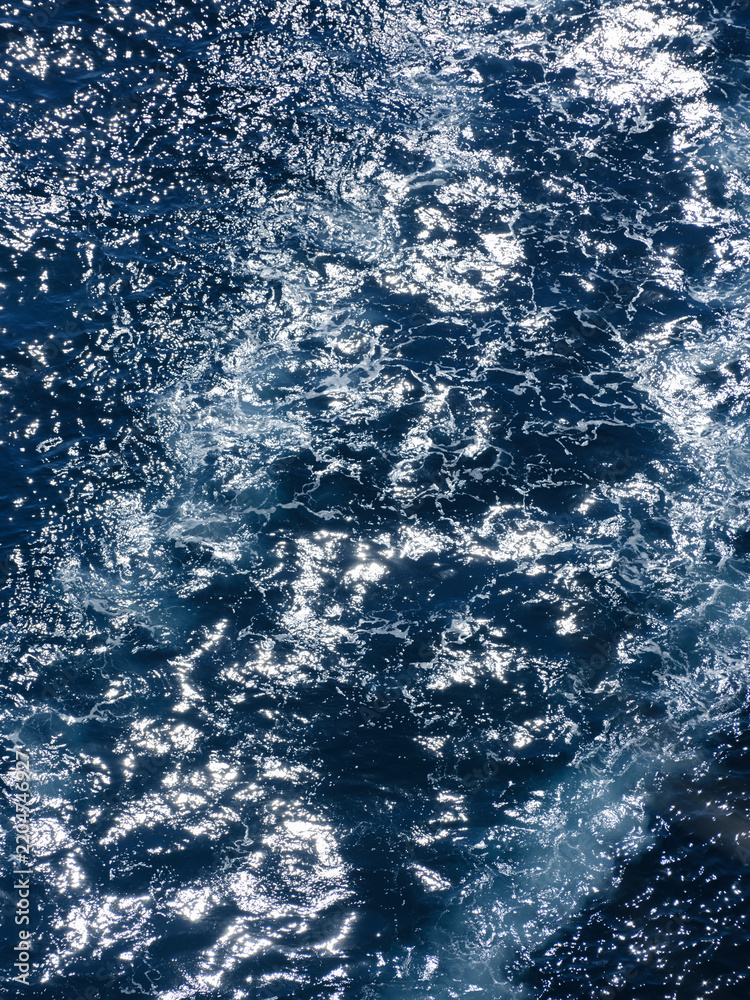 Fototapeta premium Deep blue sea behind a moving boat