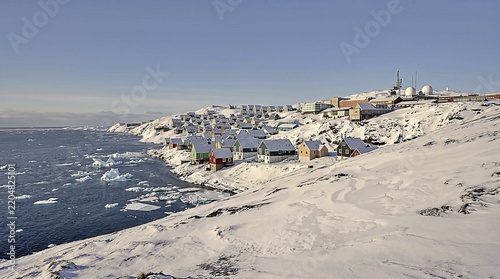 Bright Houses And Drift Ice On A Snowy Greenland Shore.